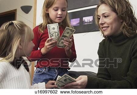 Mom giving daughters allowance View Large Photo Image Stock Image - Mom giving daughters allowance. Fotosearch