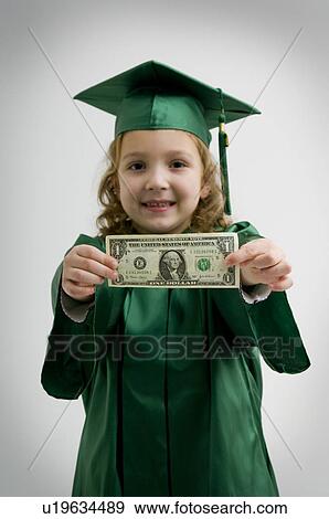 Preschool graduate holding dollar bill View Large Photo Image Stock Photo - Preschool graduate holding dollar bill. Fotosearch