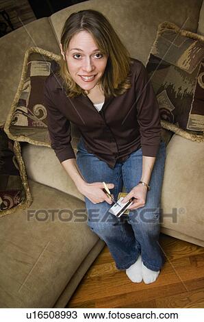 Stock Image - Woman cutting up credit card. Fotosearch