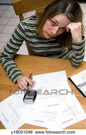 Stock Photo - Woman paying bills. Fotosearch