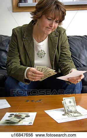 Stock Photograph - Woman paying bills. Fotosearch