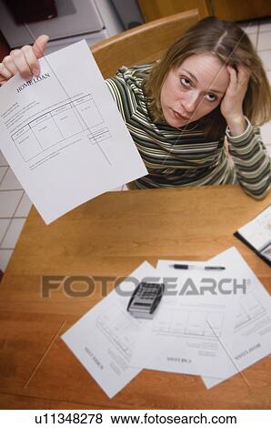 Stock Photo - Woman paying mortgage. Fotosearch