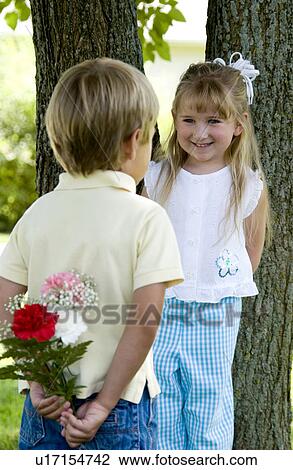 Boy giving girl flowers View Large Photo Image Stock Image - Boy giving girl flowers. Fotosearch