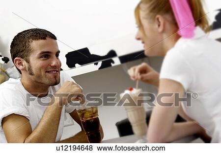 Stock Photo - Couple sharing sodas. Fotosearch