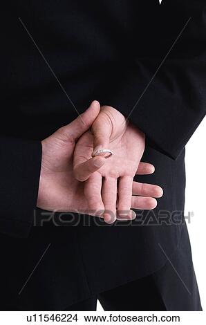 Groom with ring behind back View Large Photo Image Picture - Groom with ring behind back. Fotosearch