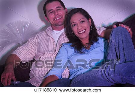 Stock Image - Hispanic couple watching television. Fotosearch