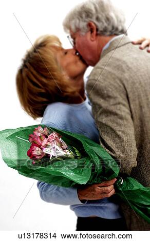 Man giving woman bouquet of flowers View Large Photo Image Picture - Man giving woman bouquet of flowers. Fotosearch