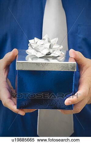 Stock Photography - Man holding gift. Fotosearch