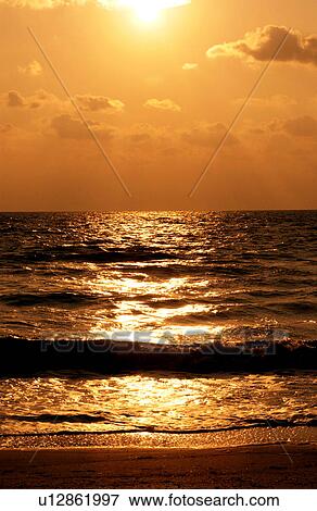 Stock Photo - Sunset over the ocean. Fotosearch