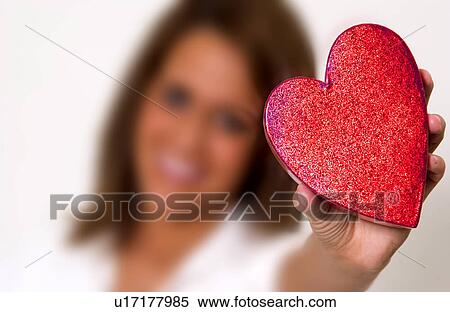 Stock Photography - Woman holding heart box. Fotosearch