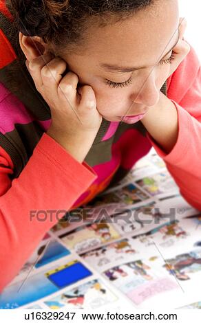 Stock Photo - African American girl reading newspaper. Fotosearch