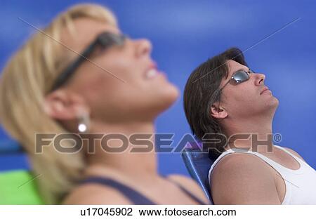 Couple lying out in the sun View Large Photo Image Stock Image - Couple lying out in the sun. Fotosearch