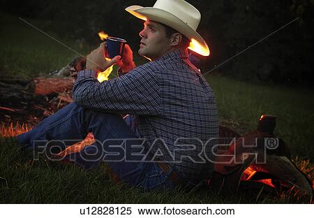 Stock Photography - Cowboy near campfire. Fotosearch
