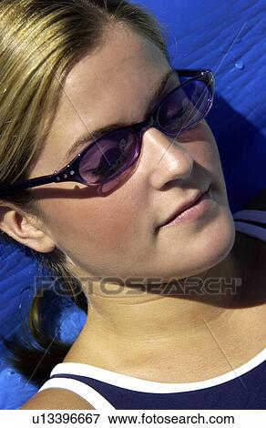 Stock Photo - Girl napping in the sun. Fotosearch