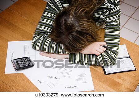 Stock Photo - Woman paying bills. Fotosearch