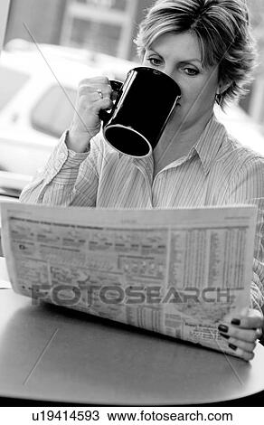 Stock Image - Woman reading newspaper. Fotosearch