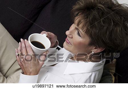 Stock Image - Woman sitting relaxing. Fotosearch