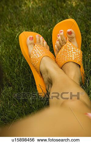 Stock Photograph - Woman wearing flip flops. Fotosearch