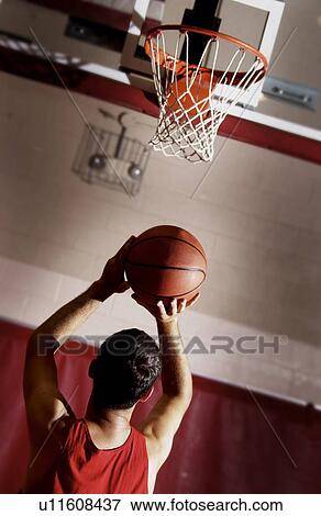 Stock Photo - Guy shooting a basket. Fotosearch