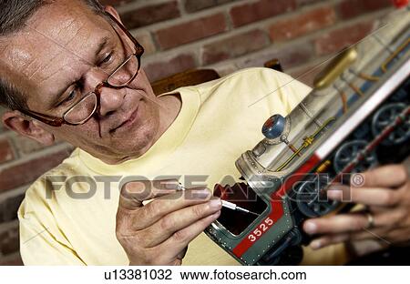 Man repairing a model train View Large Photo Image Stock Image - Man repairing a model train. Fotosearch