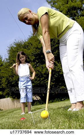 Mother and daughter playing croquet View Large Photo Image Picture - Mother and daughter playing croquet. Fotosearch