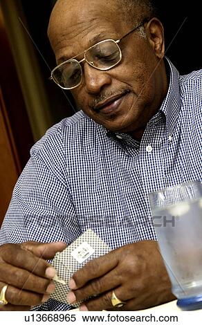 Stock Photography - Senior man playing cards. Fotosearch