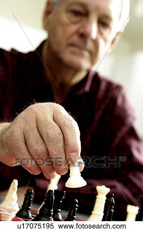 Stock Photography - Senior man playing chess. Fotosearch