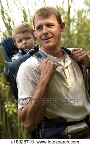 Father carrying son in backpack hiking on walk View Large Photo Image Stock Photo - Father carrying son in backpack hiking on walk. Fotosearch
