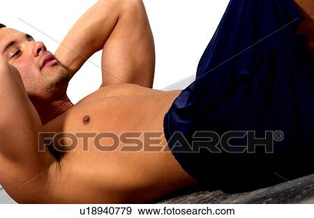 Man doing sit ups View Large Photo Image Stock Photo - Man doing sit ups. Fotosearch