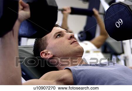 Stock Image - Man lifting weights. Fotosearch