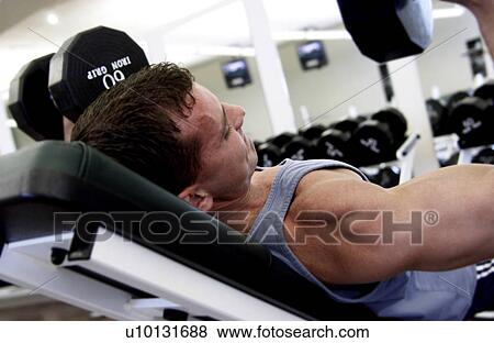 Stock Photo - Man lifting weights. Fotosearch