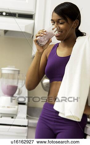 Woman drinking smoothie View Large Photo Image Stock Photo - Woman drinking smoothie. Fotosearch