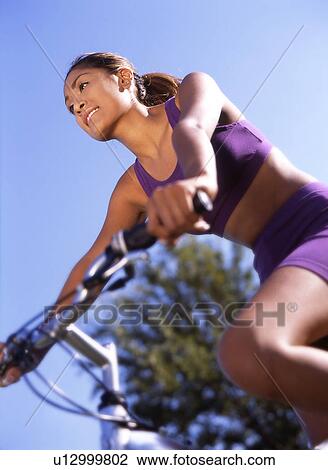 Woman riding bicycle View Large Photo Image Stock Image - Woman riding bicycle. Fotosearch