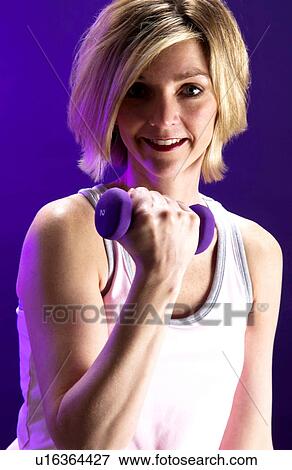 Stock Photo - Woman with weights. Fotosearch