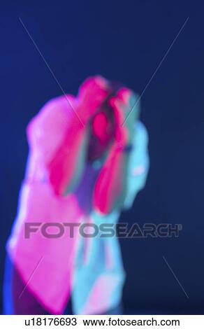 Stock Image - Blurred figure acting frustrated. Fotosearch