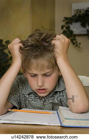 Stock Photo - Boy doing homework. Fotosearch