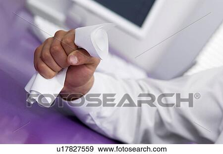 Stock Photo - Businessman at desk crumpling paperwork. Fotosearch