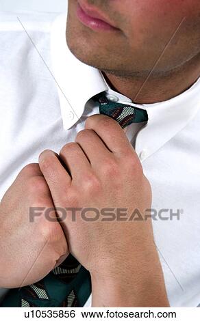 Stock Photograph - Businessman loosening his tie. Fotosearch