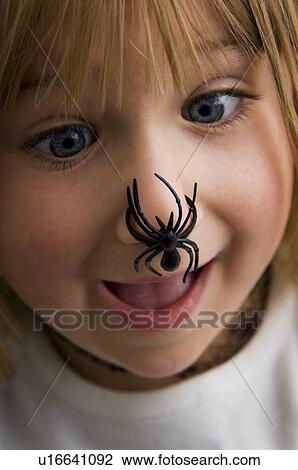 Girl with spider on her nose View Large Photo Image Stock Image - Girl with spider on her nose. Fotosearch