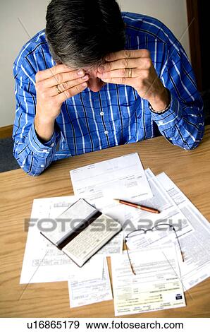 Stock Photo - Man paying bills. Fotosearch