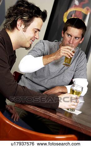 Stock Photograph - Two men drinking at a bar. Fotosearch