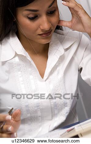 Stock Photo - Woman paying bills. Fotosearch