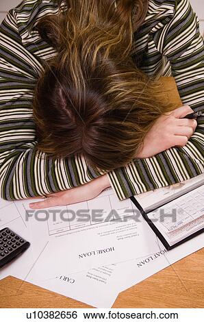 Stock Photograph - Woman paying bills. Fotosearch
