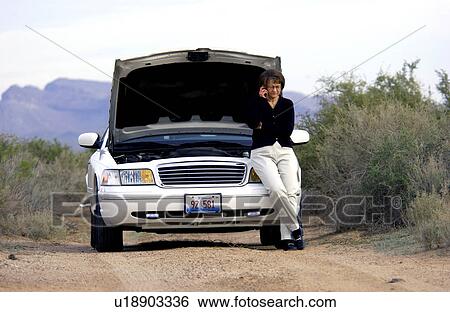Stock Photograph - Woman with broken down car. Fotosearch