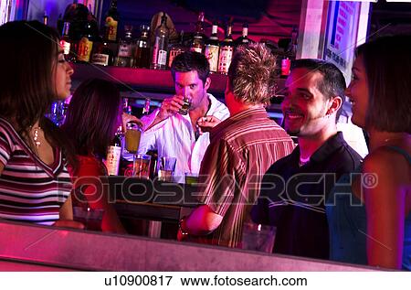 Stock Photo - Young adults at a nightclub. Fotosearch