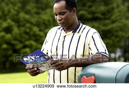 African American man getting mail from mailbox View Large Photo Image Stock Photo - African American man getting mail from mailbox. Fotosearch