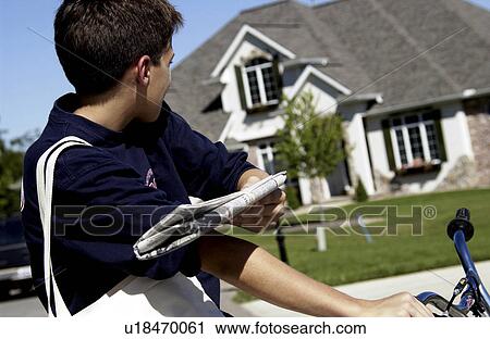Stock Image - Boy delivering newspaper. Fotosearch