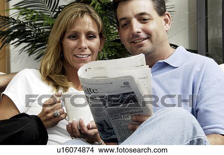 Picture - Couple reading the newspaper. Fotosearch