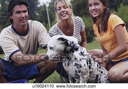 Stock Image - Family with their dog. Fotosearch