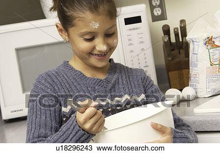 Girl stirring dough in a mixing bowl View Large Photo Image Stock Image - Girl stirring dough in a mixing bowl. Fotosearch
